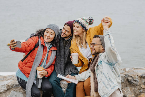 istock Group of friends outdoors having fun and taking selfie 1285973626