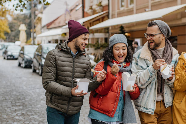 istock Friends outdoors eating fast food and having fun 1285973644