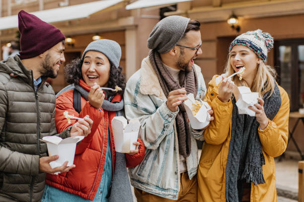 istock Friends outdoors eating fast food and having fun 1285973677