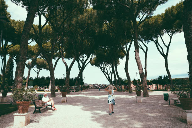 Rome, Italy - June 23, 2018: Panoramic view of Orange Garden (Giardino degli Aranci) on Aventino Hill. People walk and rest in national park of Rome. Summer day and blue sky