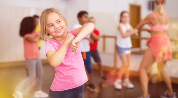 istock Girl exercising in group during dance class 1285974112