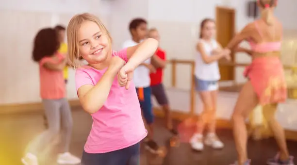 Photo of Girl exercising in group during dance class