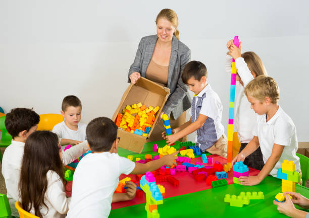 istock Group of children playing with colorful blocks 1285974934