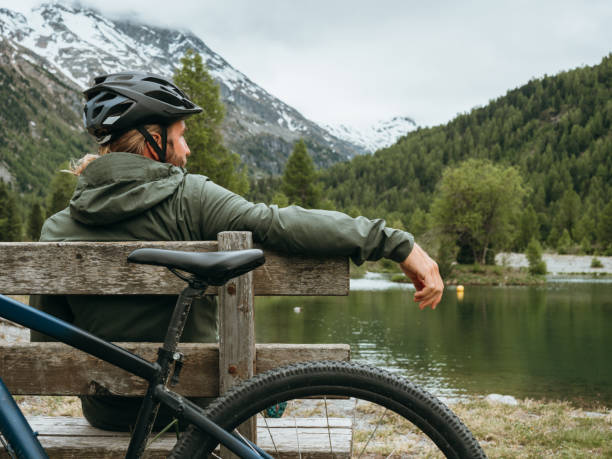 istock Mountain biker relaxes by lakeshore 1285975920