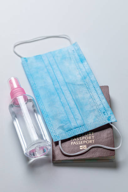 istock Protective mask, passport and disinfection liquid in coronavirus pandemic 1285977444