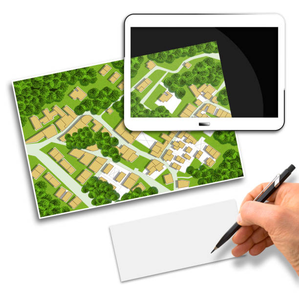 istock Imaginary cadastral map of territory with buildings, roads and land parcel - Concept image with 3D render of a digital tablet and hand writing on a white sheet 1285977697
