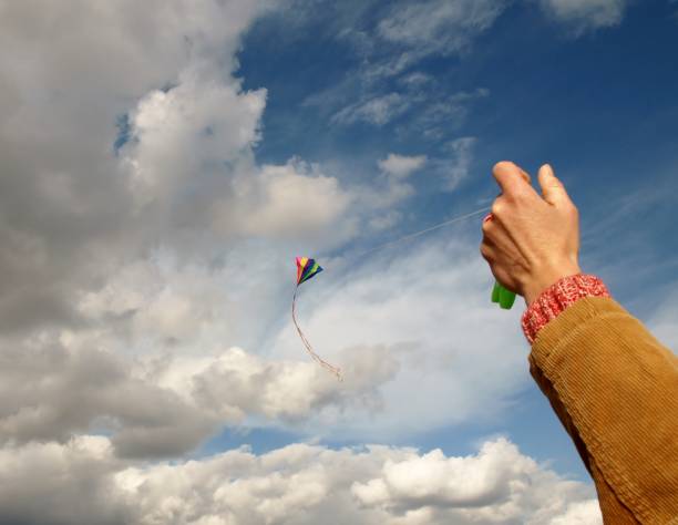 istock Hand holds dragon rope in front of sky 1285979700