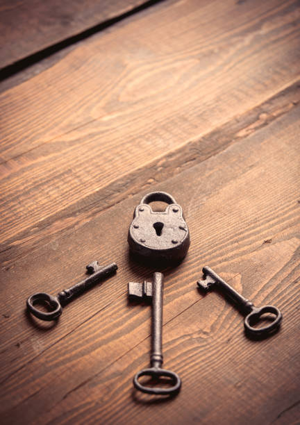 istock metal lock and key on wooden table 1285980030