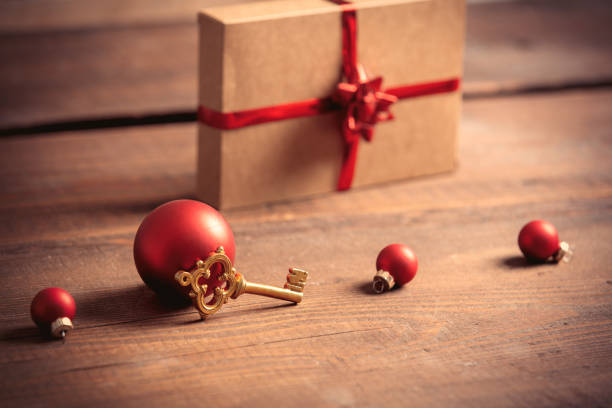 istock Little key and Christmas box on wooden table 1285980099
