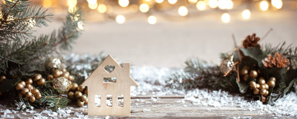Christmas cozy background with decor details, snow and blurry lights copy space. Winter cozy background with festive decor details, snow on a wooden table and bokeh. The concept of a festive atmosphere at home. hygge photos stock pictures, royalty-free photos & images