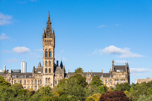 Front view looking over part of Kelvingrove Park to the imposing architecture of Glasgow University's main building, in the city's West End.