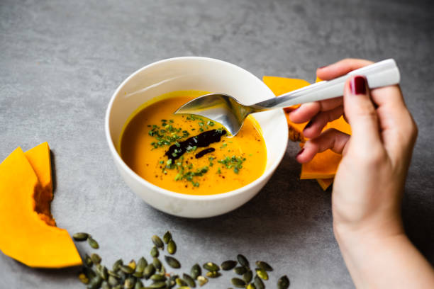 istock Homemade pumpkin soup on rustic background 1285981455