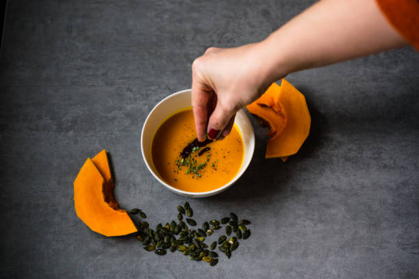 istock Homemade pumpkin soup on rustic background 1285981504