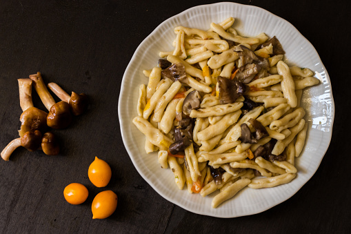 Cavatelli with pioppini mushrooms and yellow cherry tomatoes. Homemade pasta