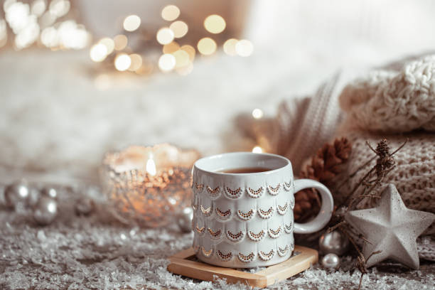 istock Cozy winter background with a beautiful cup, decor details and bokeh copy space. 1285984040
