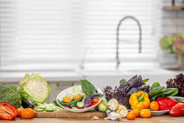 istock Fresh vegetables in the salad making process close up. 1285985423