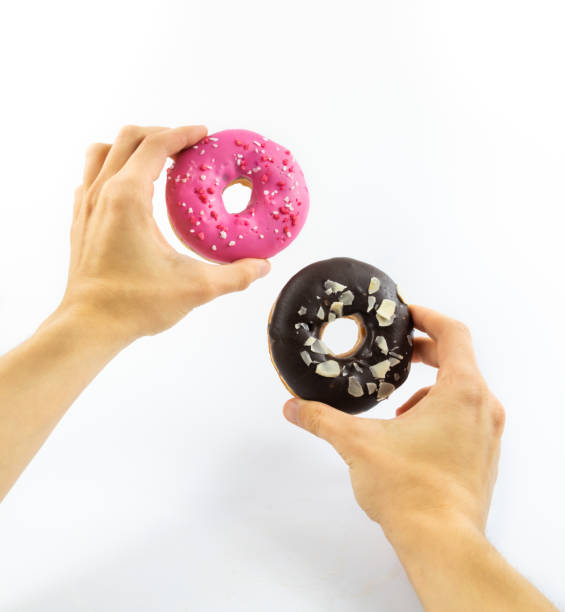 istock Two donuts instead of eyes funny gesture on white isolated background banner 1285985684