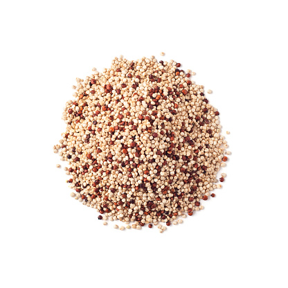 Top view of raw quinoa seeds heap isolated on white background
