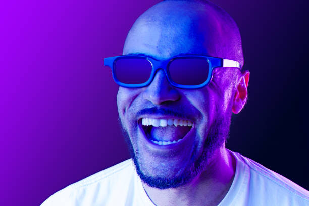 istock Positive black man in glasses posing in neon lights 1285989447