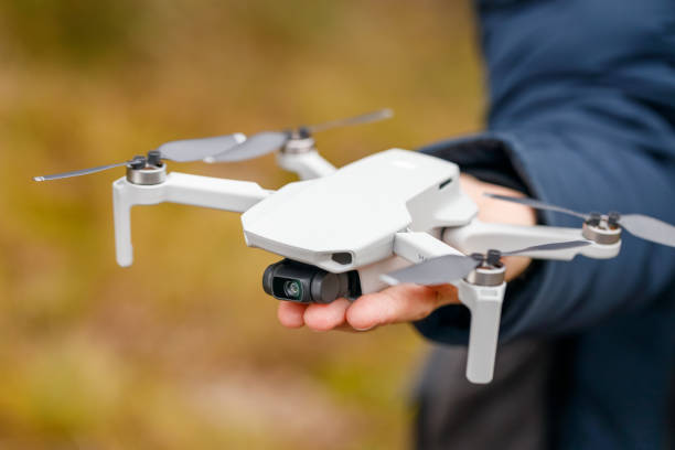 DJI mavic mini drone quadcopter in hand man close-up. stock photo