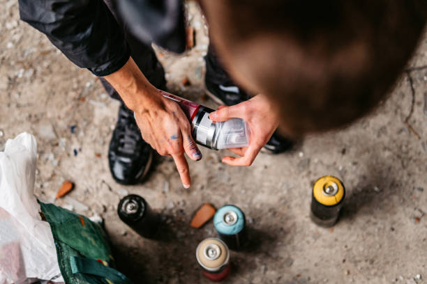 Artist picking aerosol paint spray bottle, close up.