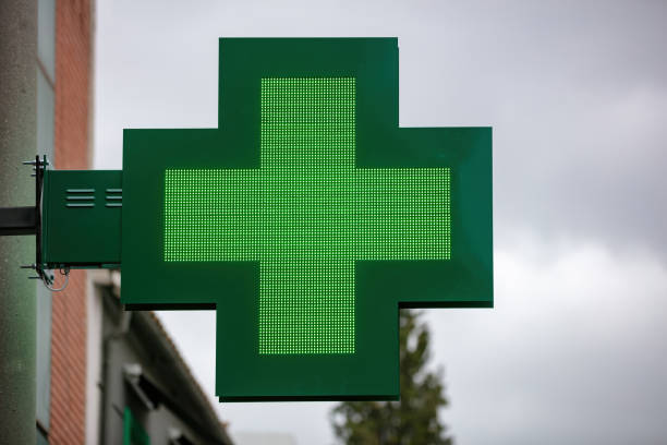 istock Green cross hanging outside drugstore 1285990417