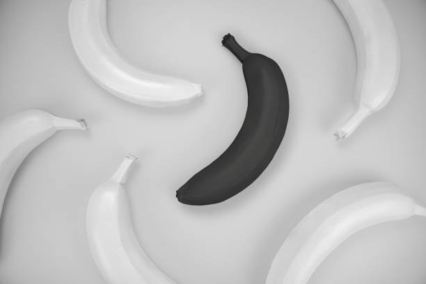 istock Abstract banana pattern photography with white and one black banana 1285991117