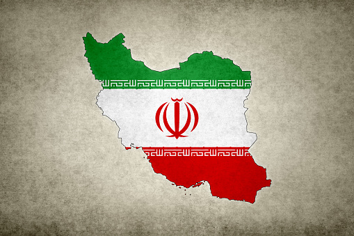 Iran flag waving on the flagpole on a sky background