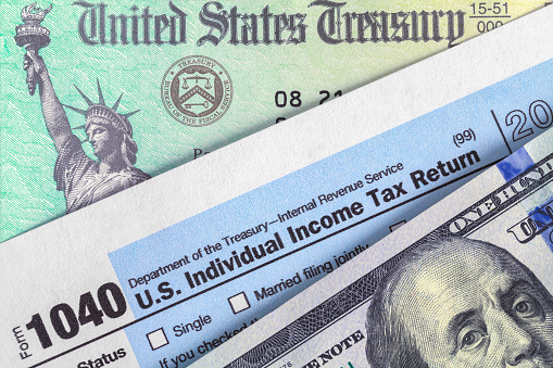 Form 1040 with Tax Refund Check and Money