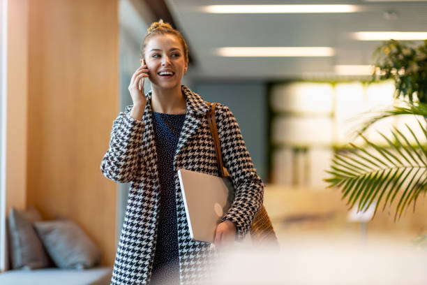 istock Young businesswoman using a smartphone in a modern office 1285991973