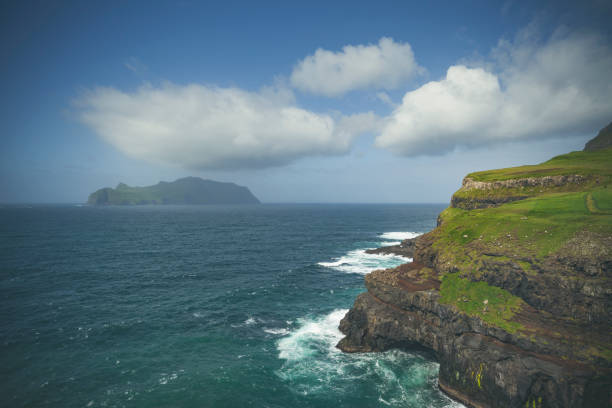 mykines island seen from the village of gásadalur, vágar island, faroe islands.