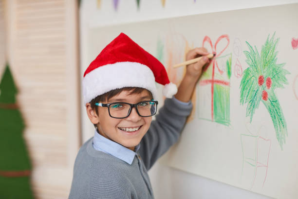 istock Smiling Boy Drawing on Walls on Christmas 1285993395