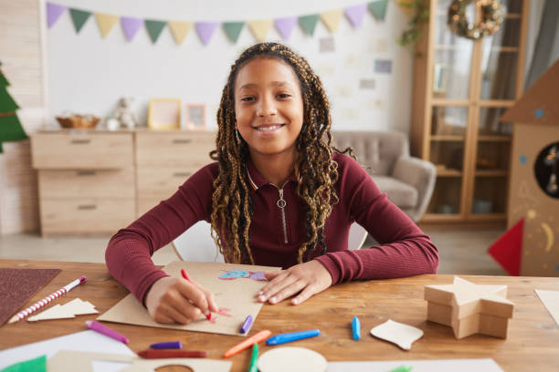 istock Smiling African-American Girl Enjoying Drawing 1285993456