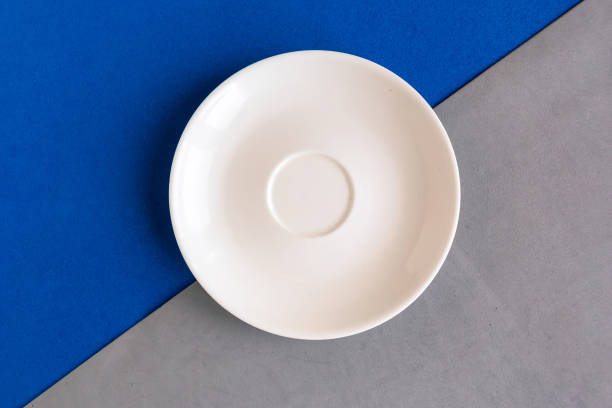 istock Empty plate on grey and purple background. Copy space for the text. Minimal concept 1285993549
