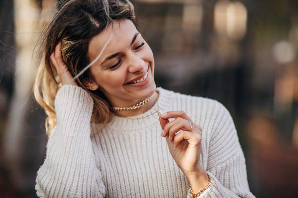 One beautiful young cheerful woman standing in autumn forest.