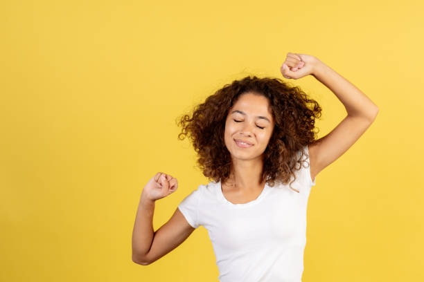 young african american woman on yellow copy space background - wake up stretching women black imagens e fotografias de stock