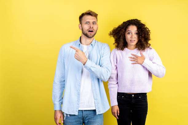 istock Mixed race friends standing on yellow background 1286000112