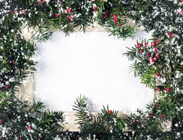 istock Creative layout made from Christmas tree branches with red berries, frame paper card note and snow. 1286002193
