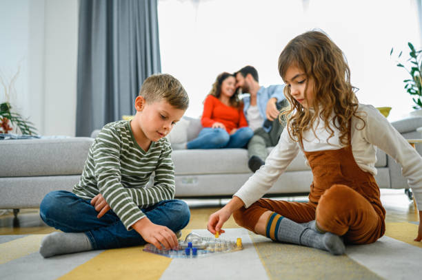 istock Cheerful children playing board games. 1286003994
