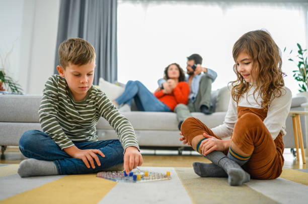 istock Cheerful children playing board games. 1286004734
