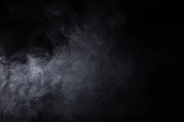 istock Cloud of white smoke on a black background closeup 1286005274