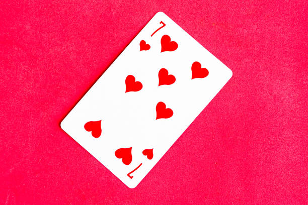 Seven of Hearts playing card, red background.