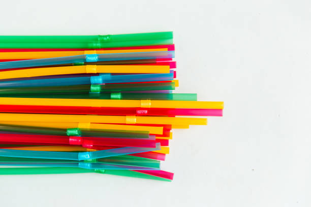 istock Multicolored plastic drinking cocktail straws on white background, top view. Make a cocktail. 1286006307