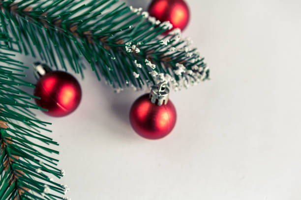 istock christmas tree branches with baubles on white background, copy space for the text 1286006377