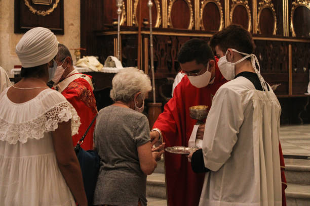 Celebration of a Catholic mass in Cuba Havana - Cuba; November 15, 2020: Celebration of a Catholic mass. They celebrate a mass for the 501 anniversary of the founding of Havana in the Cathedral of Havana. cardinal clergy stock pictures, royalty-free photos & images