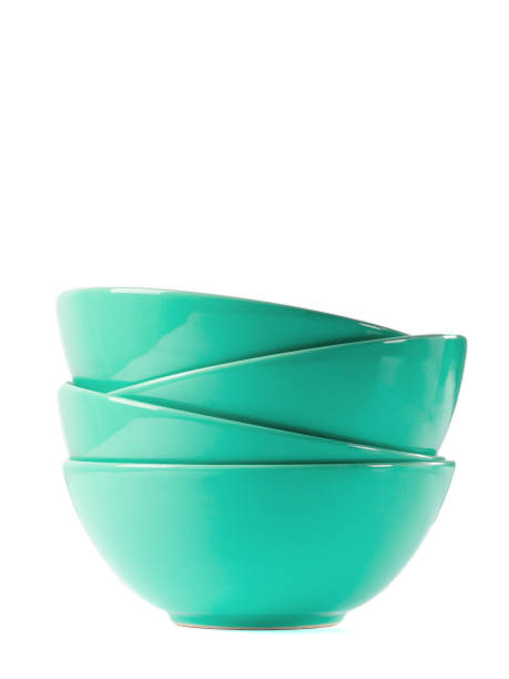 Stack of green bowls isolated on white.
