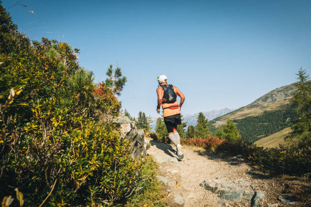 istock Senior man races along a trail in the mountains 1286011792