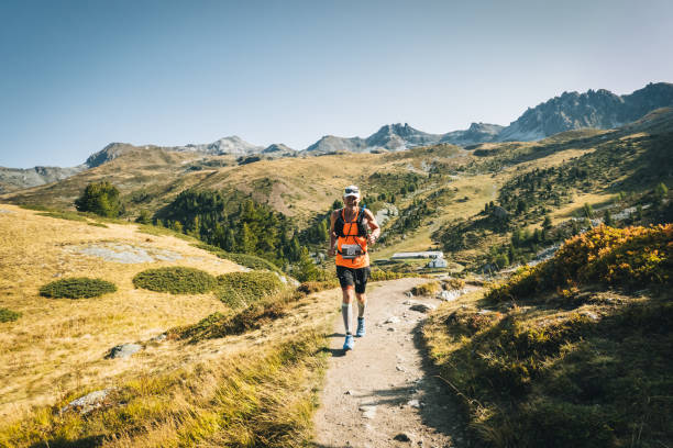 istock Senior man races along a trail in the mountains 1286011804