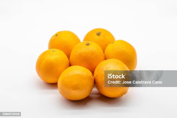 Seven Colorful Oranges Isolated On White Background Stock Photo - Download Image Now