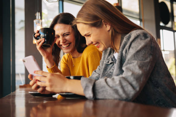 istock Two friends having fun at a coffee shop 1286013063